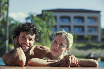 Couple relaxing at poolside  portrait