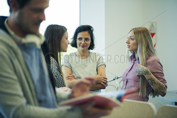 Colleagues chatting in office