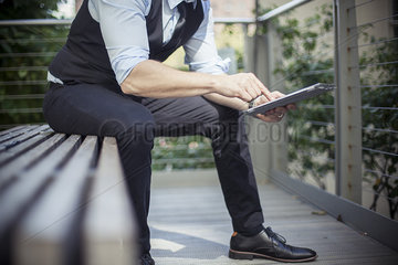 Man using digital tablet outdoors  cropped
