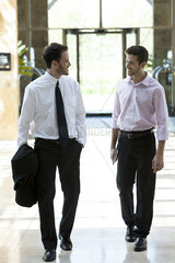Business colleagues chatting while walking together