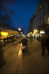 France  Paris  person riding motorcycle on street at twilight