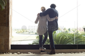 Couple looking out window at resort