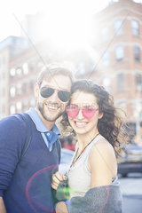 Couple standing together on city street  portrait