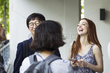 Young adult friends hanging out and laughing
