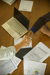 Business associates shaking hands during meeting
