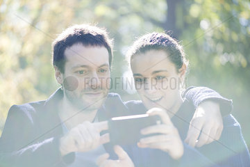Man getting camera ready for selfie with girlfriend