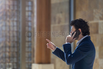 Businessman negotiating on cell phone