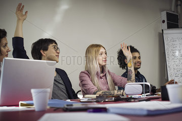 Office workers voting during business meeting