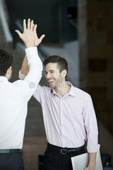 High-five between business colleagues