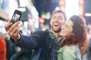 Young couple taking selfie in Times Square  New York City  New York  USA