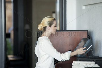 Waitress using computer in restaurant