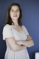 Woman with arms folded across chest  portrait