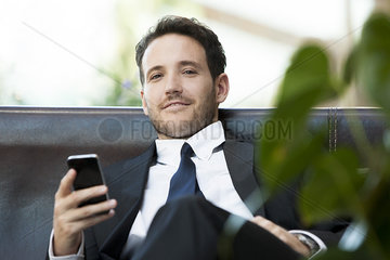 Business executive using smartphone