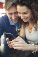 Couple looking at smartphone together