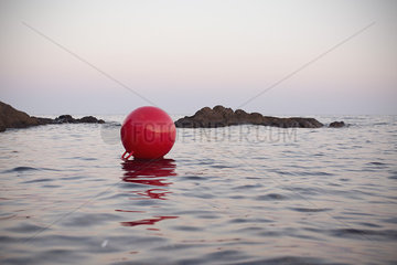 Buoy floating on body of water