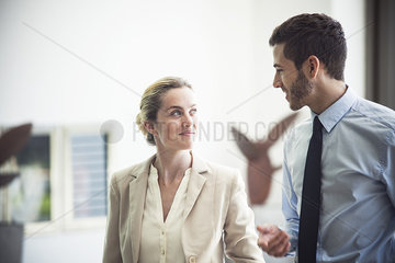 Business colleagues talking together in office
