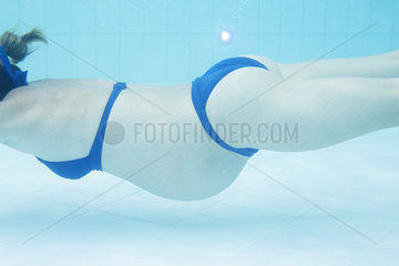 Pregnant woman exercising in swimming pool