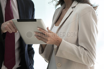 Business associates working together using digital tablet