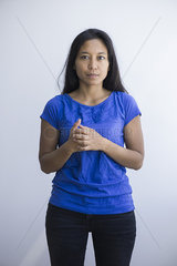 Woman standing with clasped hands  portrait