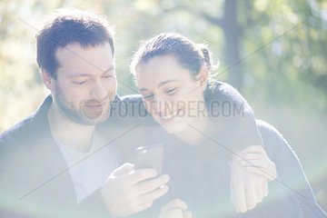 Couple using mobile app on smartphone for navigation