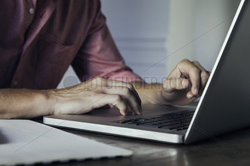 Man using laptop computer  cropped