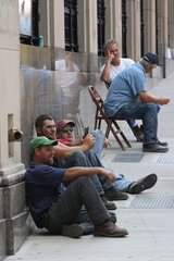 Boston  USA  Arbeiter sitzen auf der Strasse und auf Stuehlen und warten