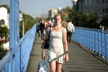 Brest  Weissrussland  eine junge  schoene Frau auf einer Fussgaengerbruecke