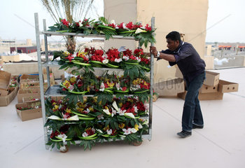 Dubai  Vereinigte Arabische Emirate  Mann schiebt einen Wagen mit Blumengestecken