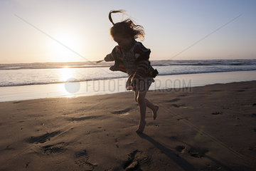 Little girl running on beach