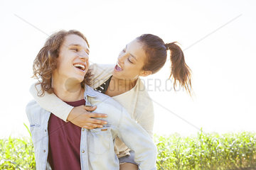 Man giving girlfriend piggyback ride