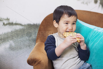 Little boy eating cookie