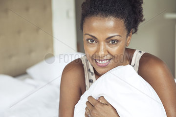 Woman holding pillow  portrait