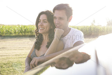 Couple taking break from road trip to enjoy view