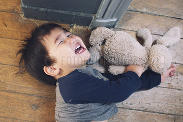 Little boy playing with stuffed toy