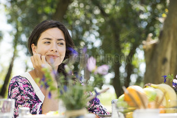 Woman sitting at picnic table
