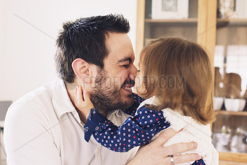Father and daughter rubbing noses