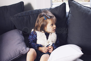 Little girl sitting on couch