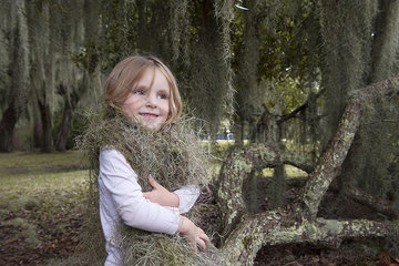 Little girl wrapped up in Spanish moss  Jekyll Island  Georgia  USA