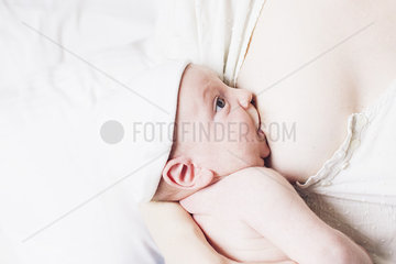 Mother breast feeding infant son