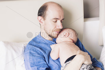 Baby napping on father's chest
