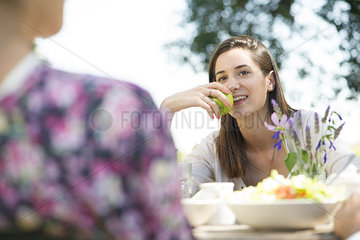 Woman enjoying meal outdoors with friends