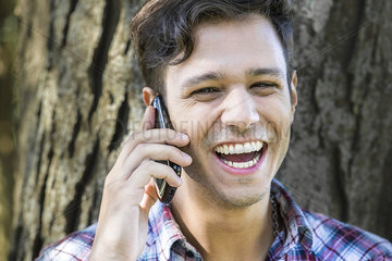 Man having lighthearted conversation on cell phone