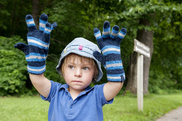 Little boy wearing oversized winter gloves  portrait