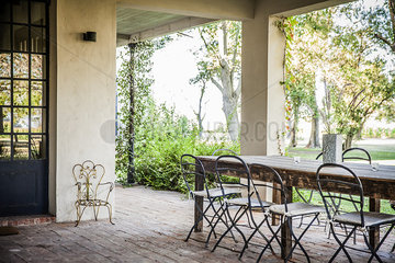 Table and chairs set on house veranda