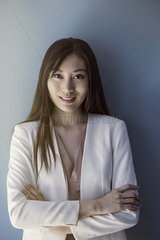 Businesswoman smiling with arms folded  portrait