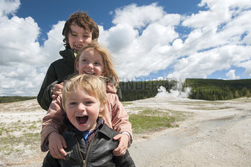 Young siblings posing for portrait at Yellowstone National Park  Wyoming  USA