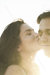 Woman kissing boyfriend on cheek