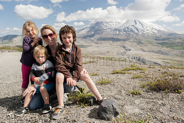 Mother and children posing in front of Mount St. Helens  Washington  USA