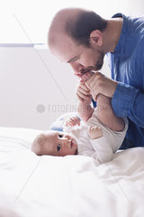 Father kissing infant son