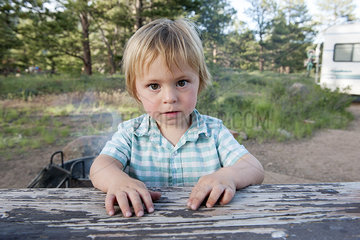 Little boy sitting at picnic table  portait